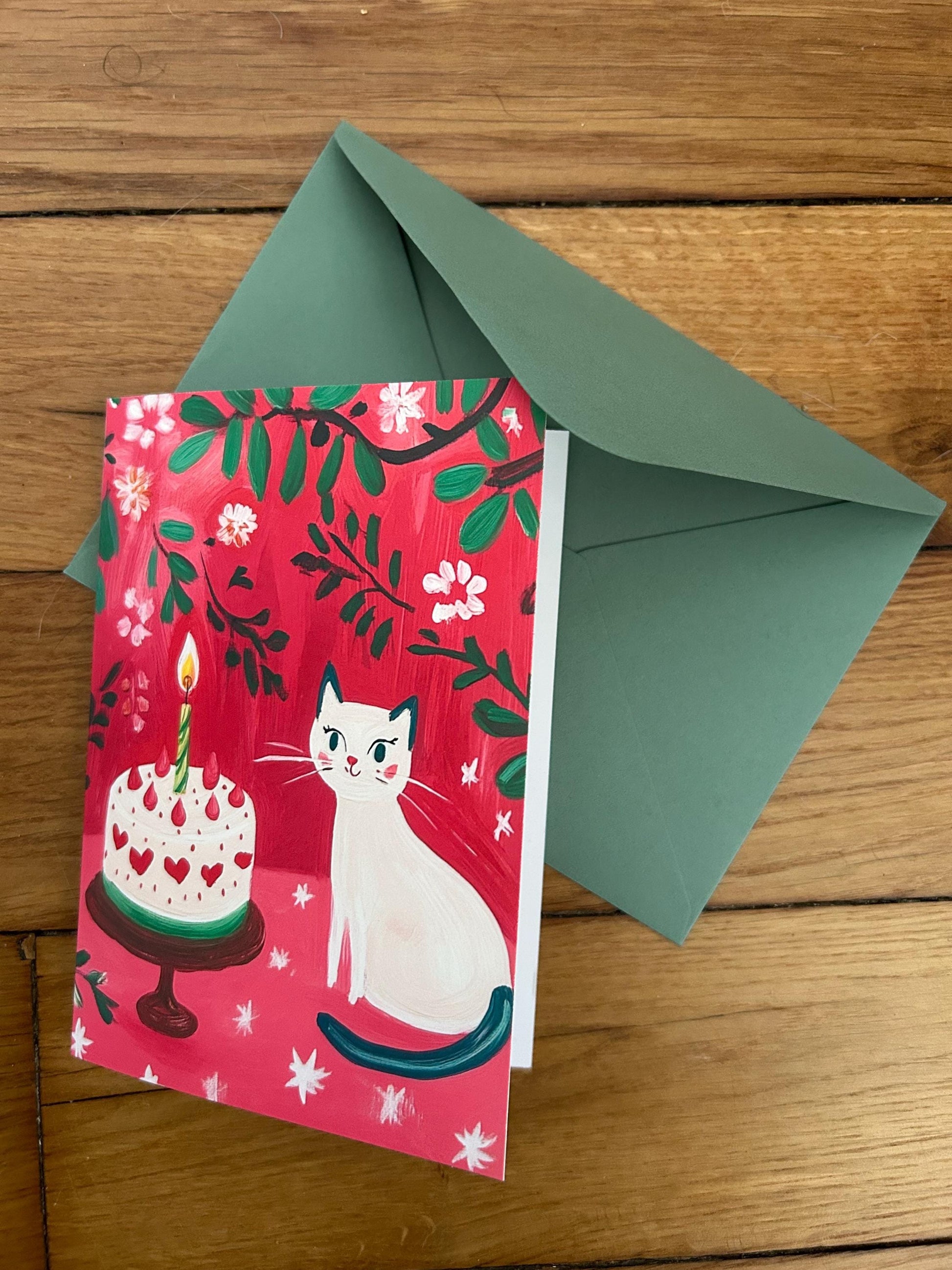 Carte anniversaire chat blanc  – illustration festive avec gâteau, cœurs et fleurs – papeterie joyeuse et poétique - A6